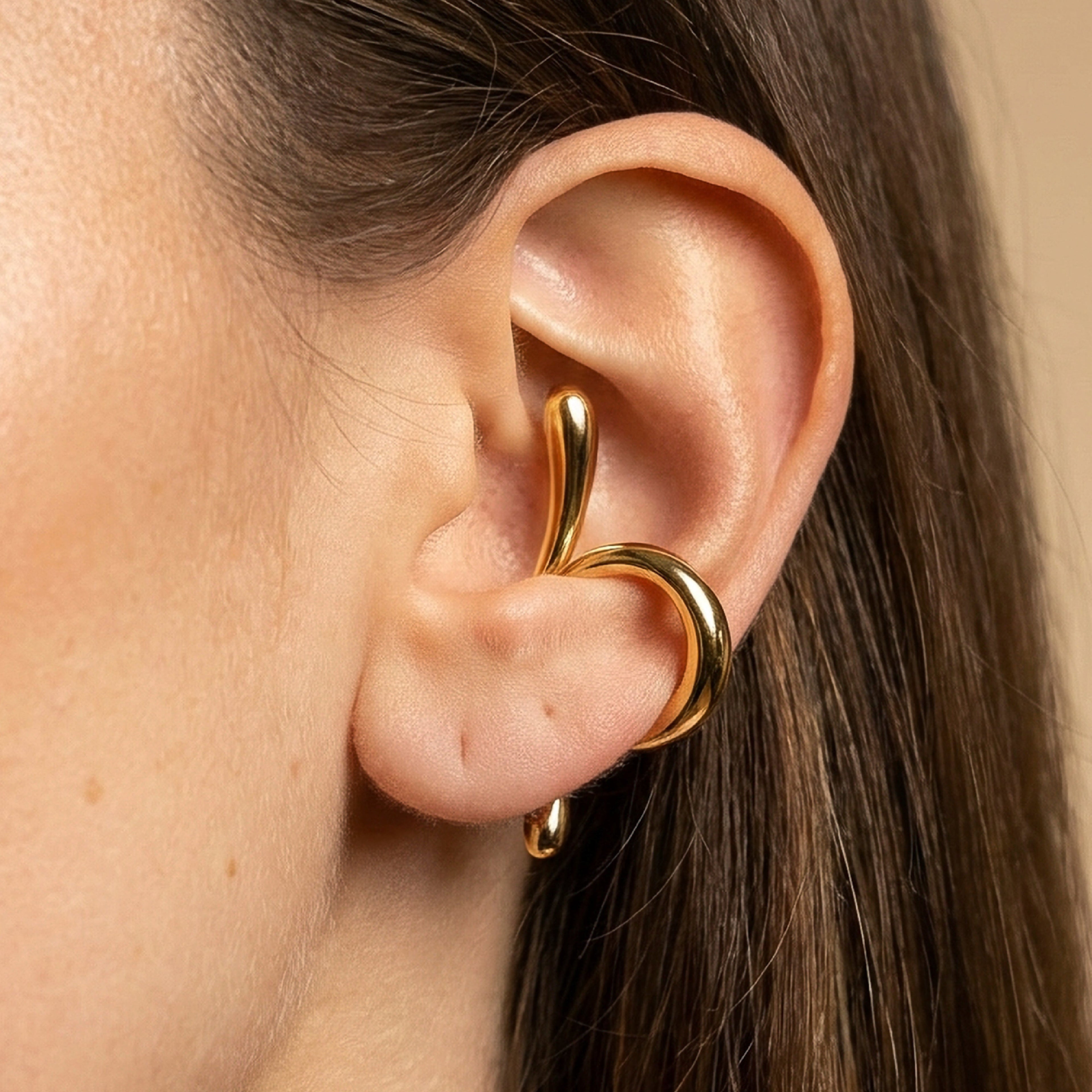 Silver cuff earring design showcased on a model's ear, emphasizing unique cuff style and elegance.