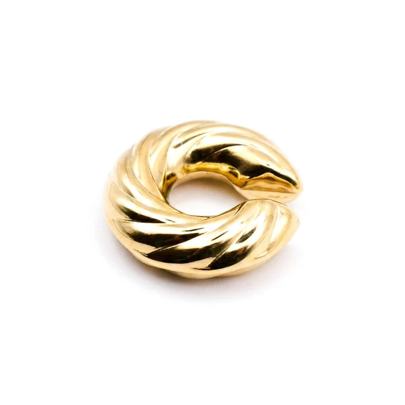 Silver cuff earring design showcased on a model's ear, emphasizing unique cuff style and elegance.